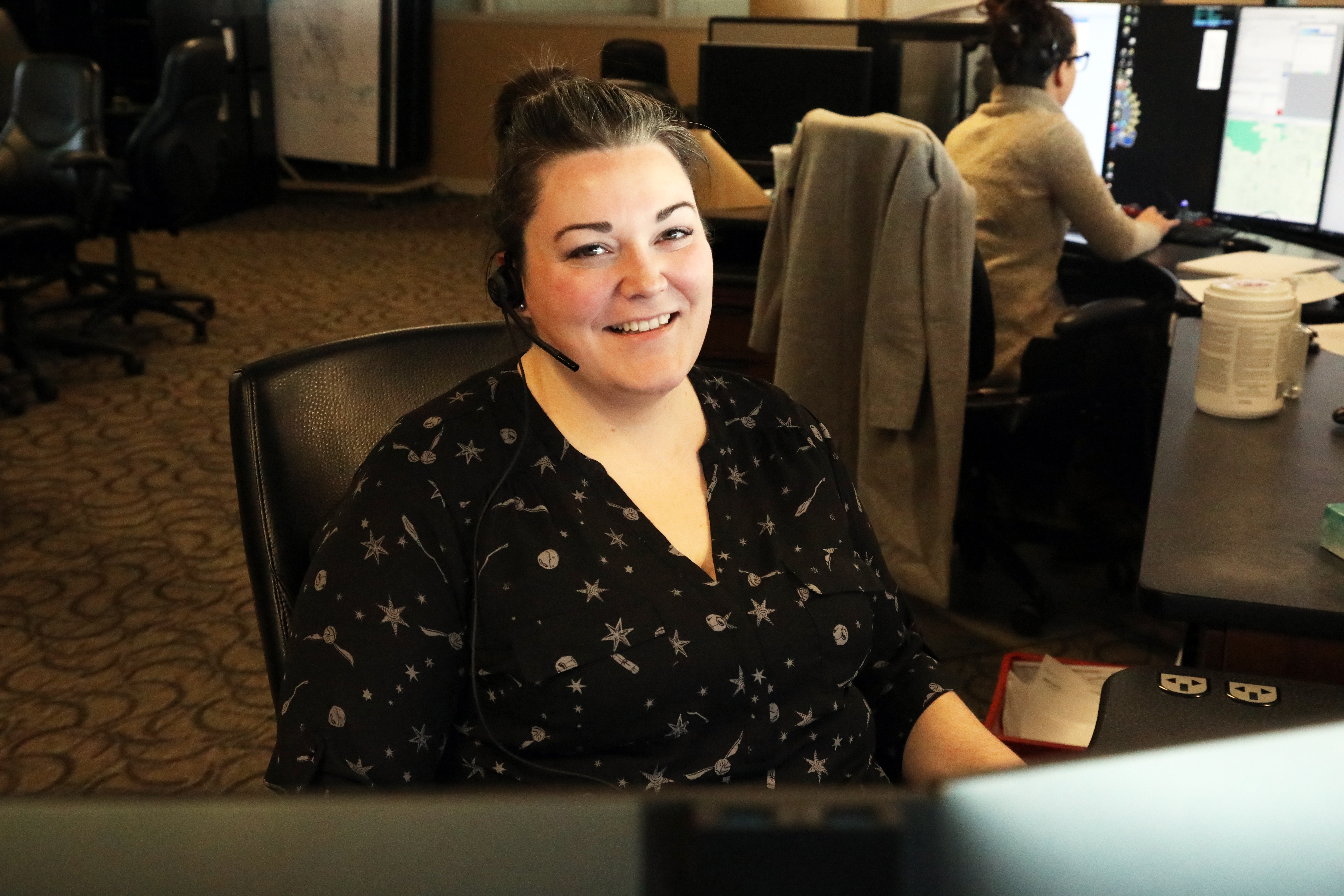 Brianne Bradley 911 dispatcher sitting and smiling