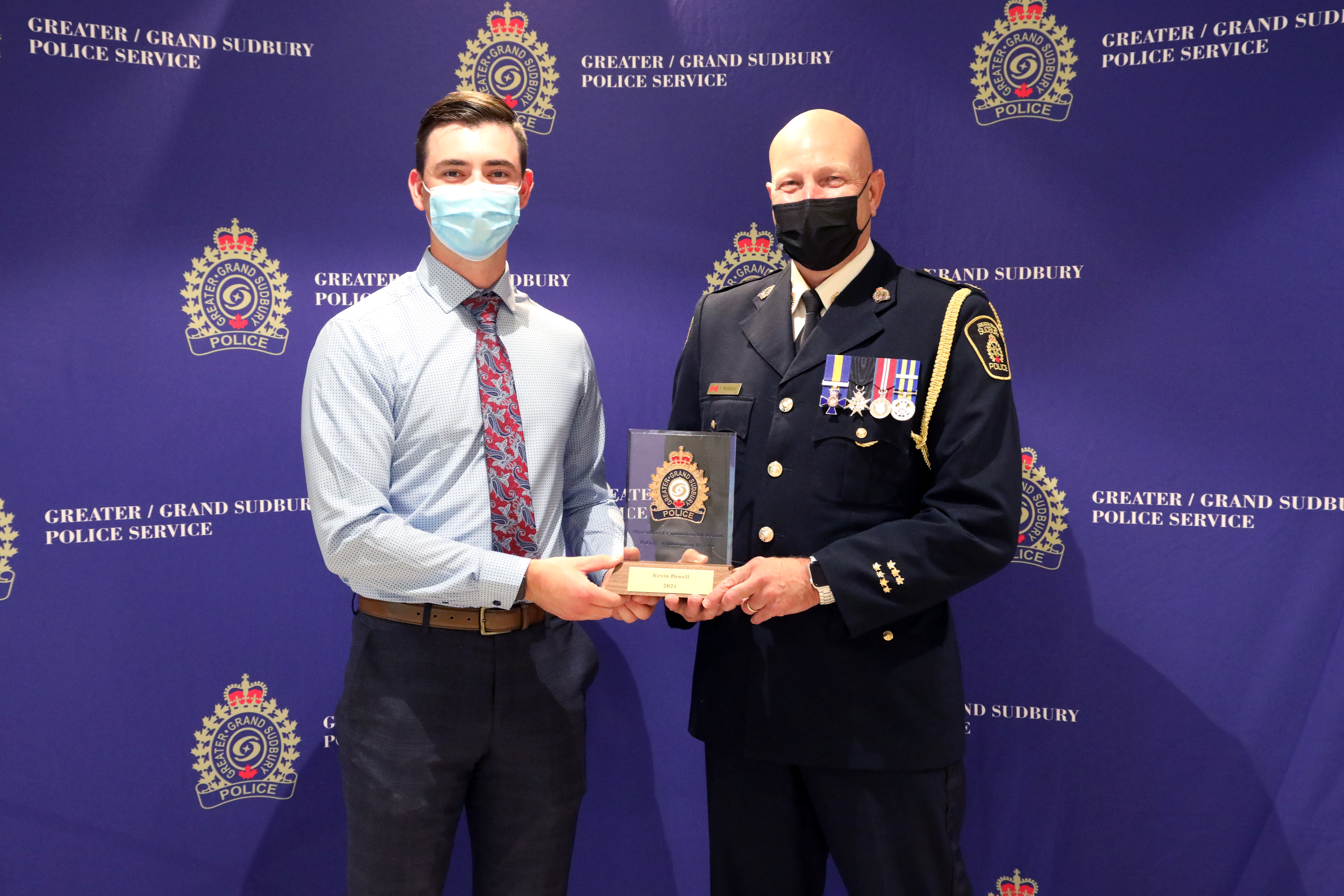 Kevin Powell and Chief Pedersen two men standing holding an award