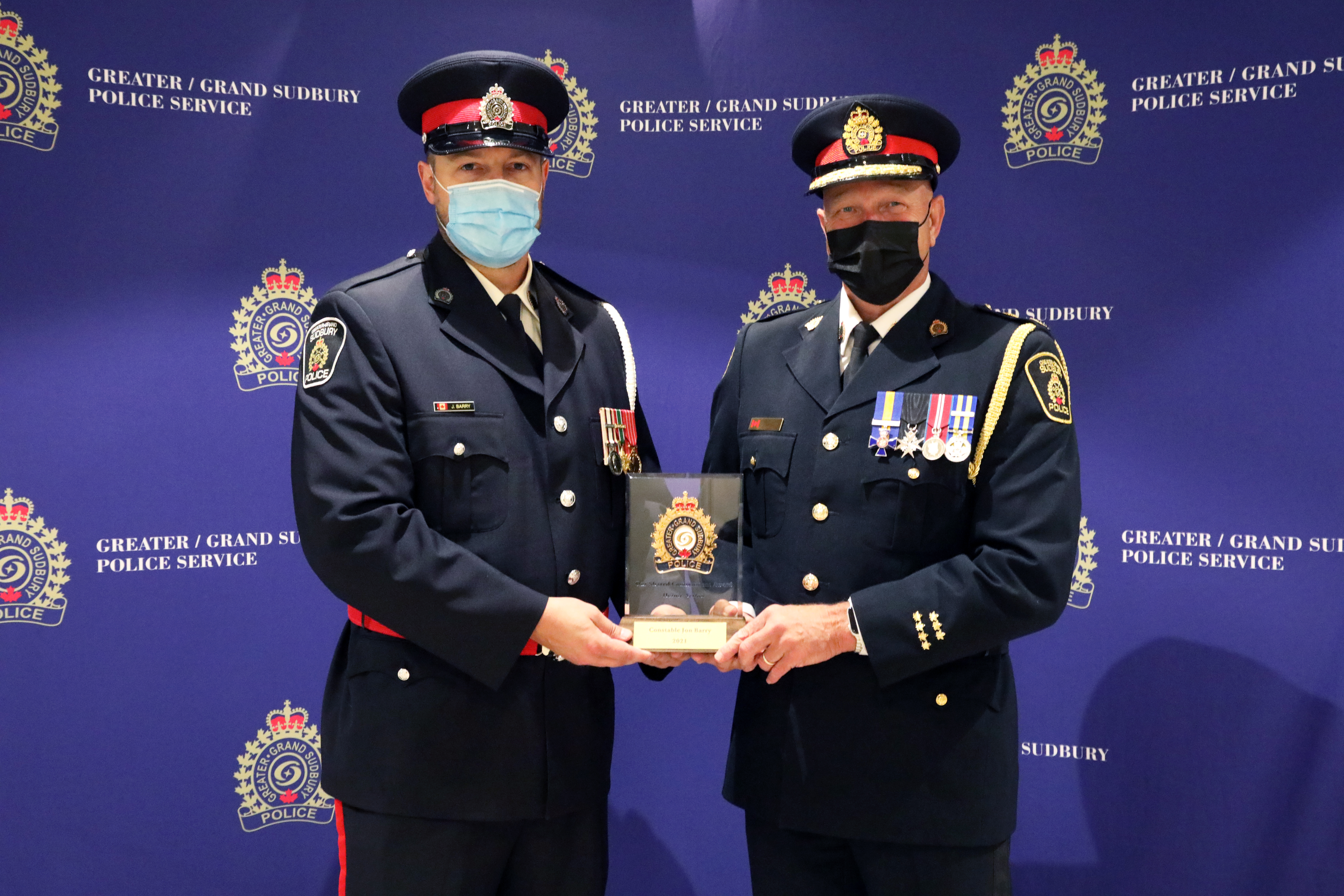 Cst. Jon Barry and Chief Pedersen Police Officer and Chief holding award
