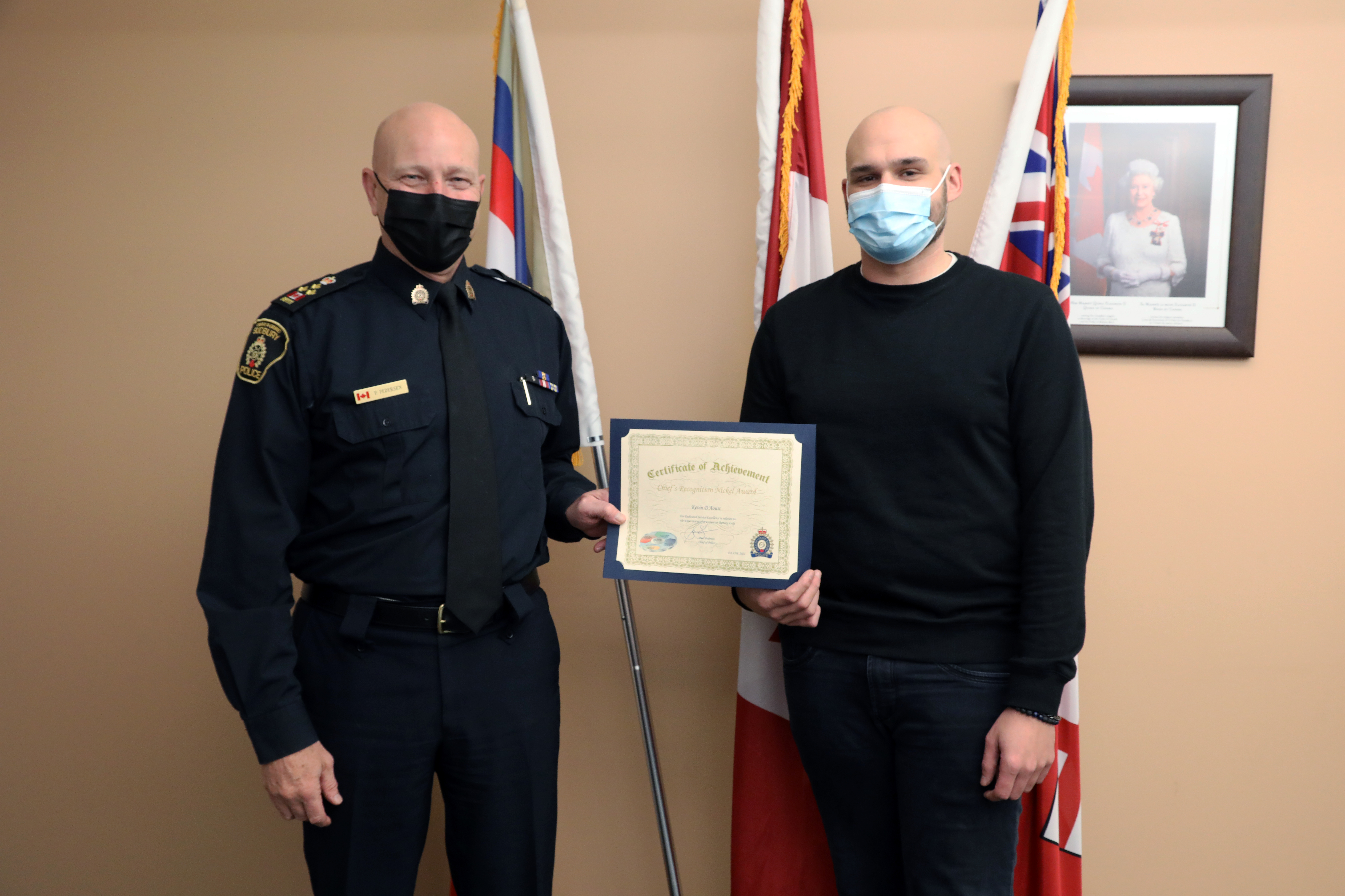 Chief Pedersen and Kevin D'Aoust Chief of police and man standing holding certificate