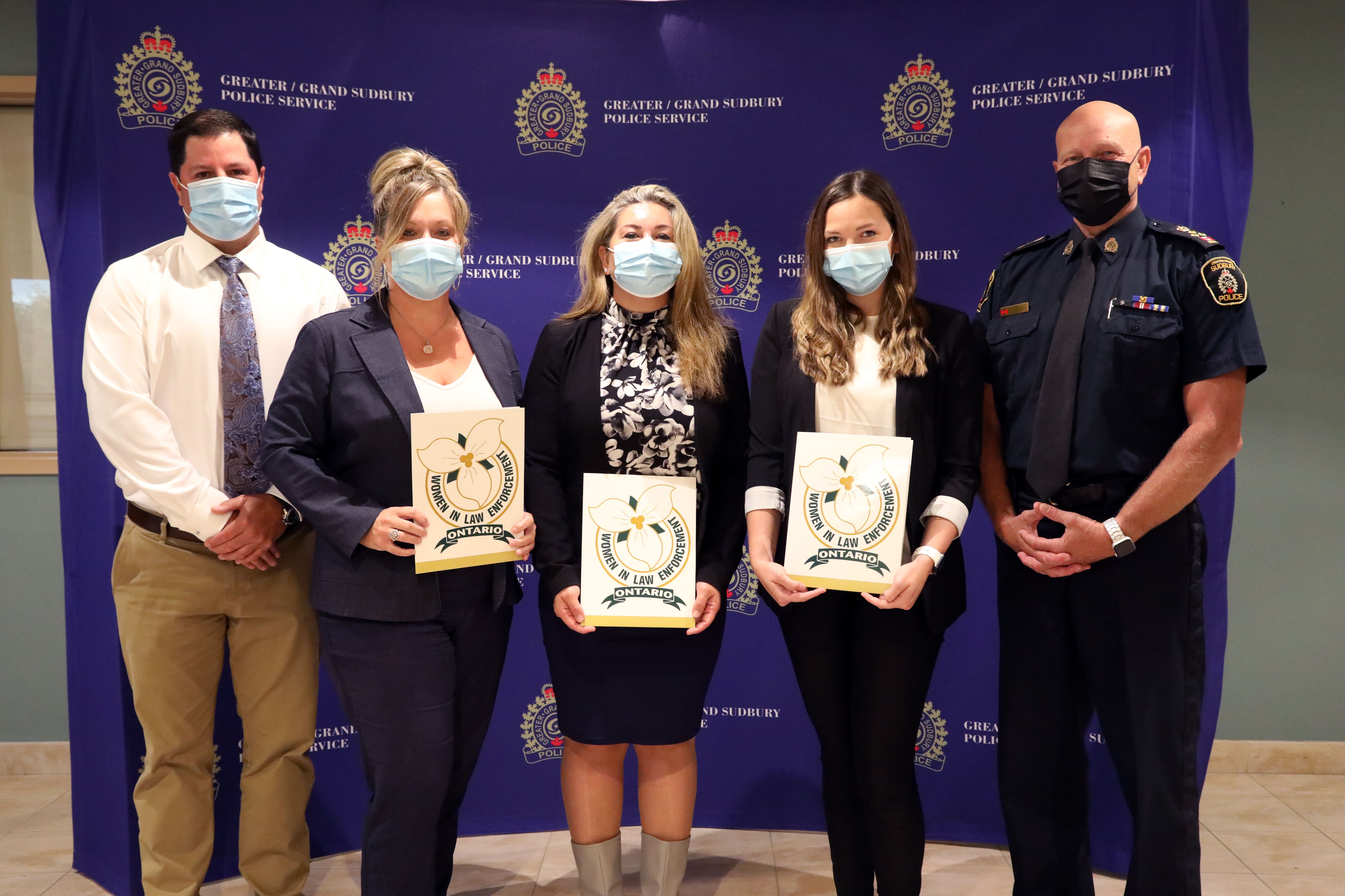 Award nomination recipients five people wearing masks standing and holding certificates