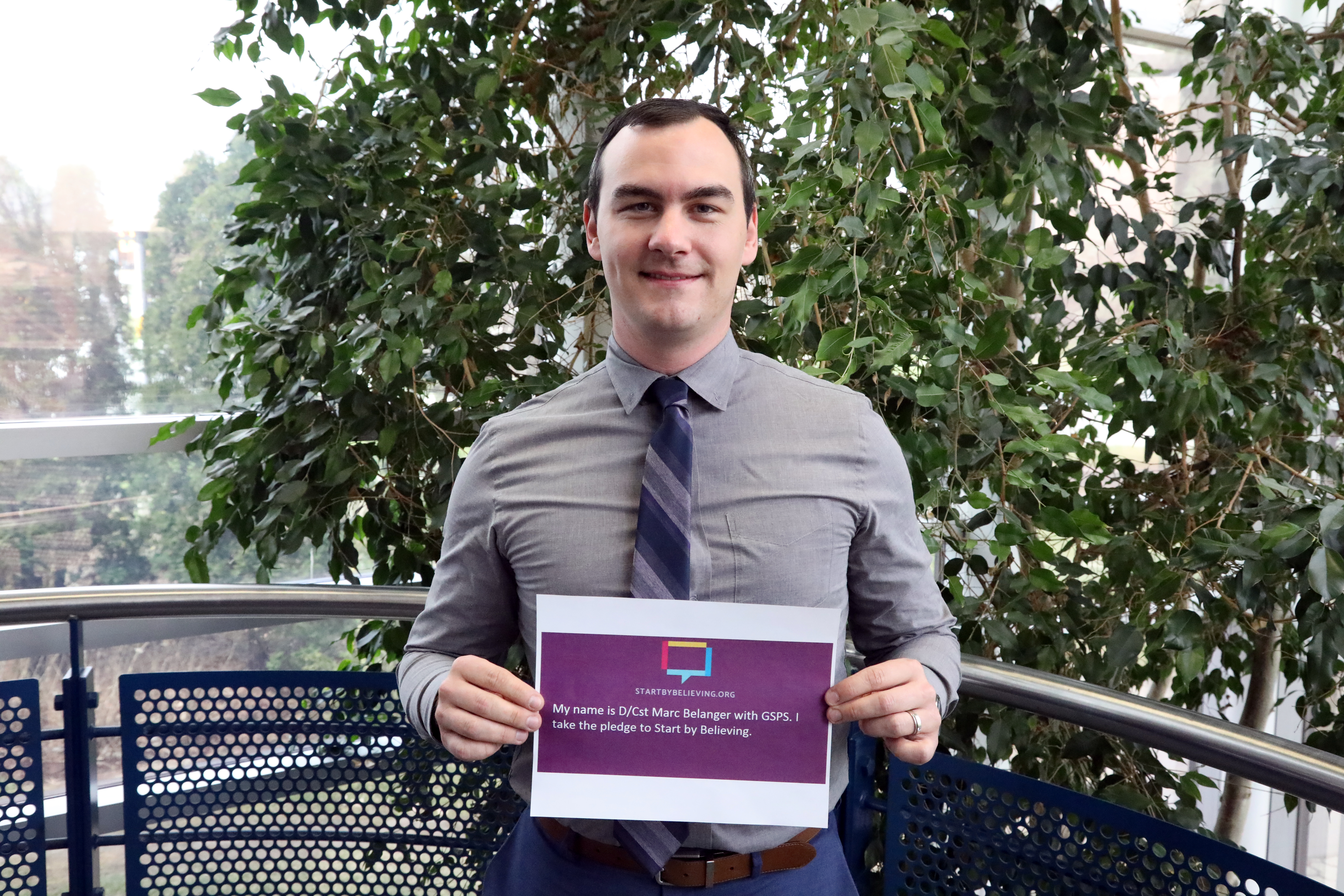 Detective Constable Marc Belanger Detective Constable holding sign