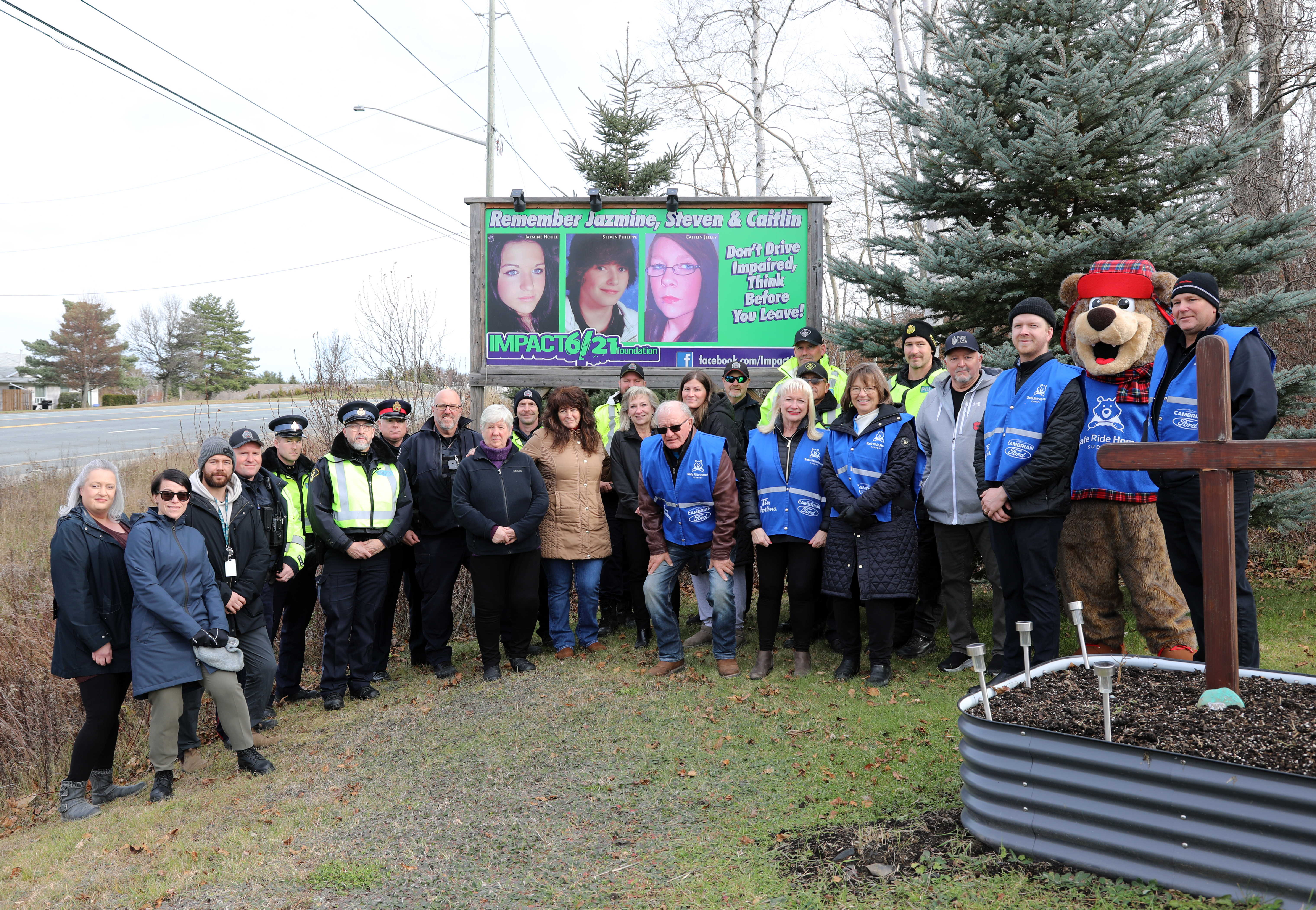 Remembering Caitlin Jelley, Jazmine Houle and Steven Philippe group of people standing in front of sign outside