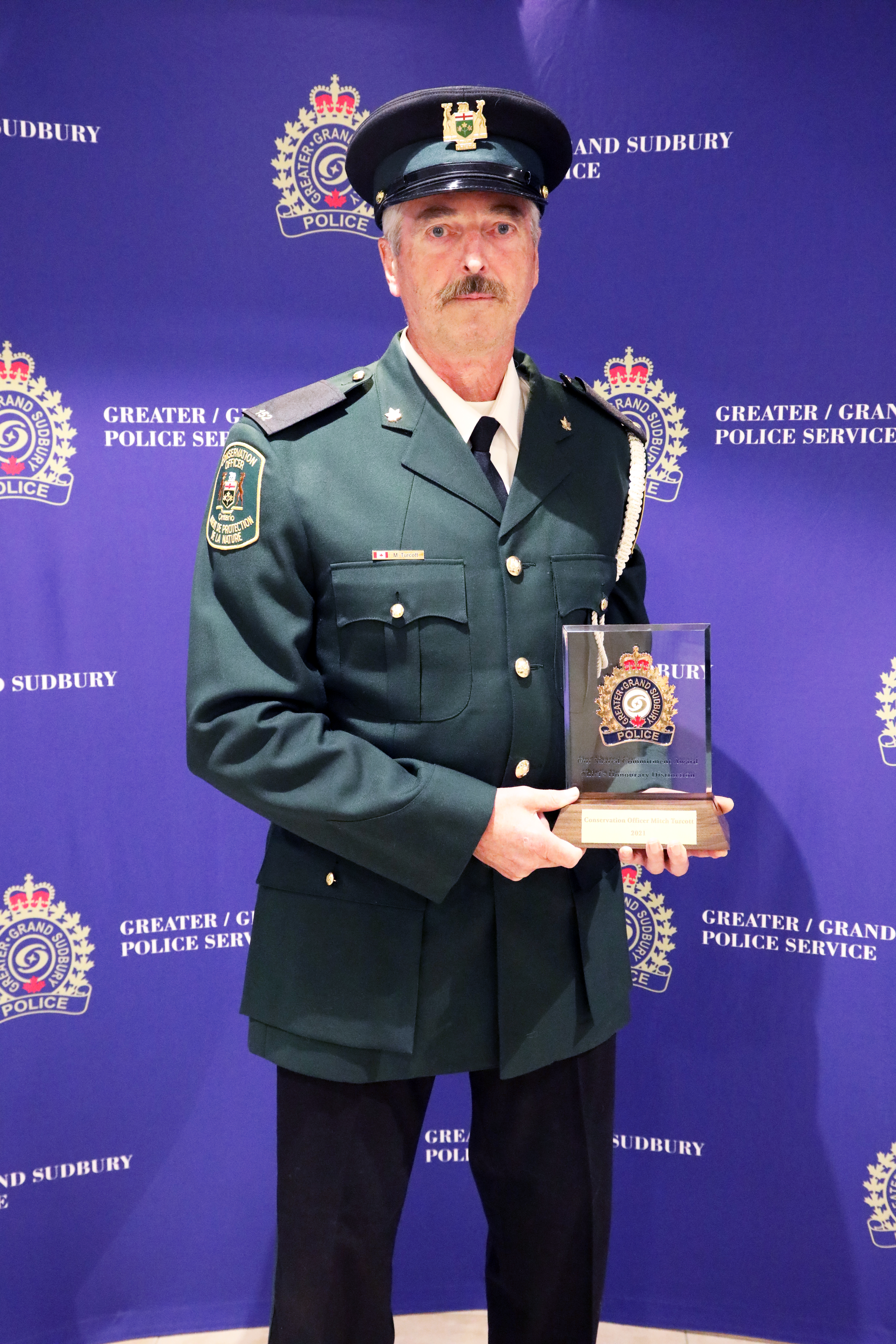 CO Mitch Turcott man in uniform holding award