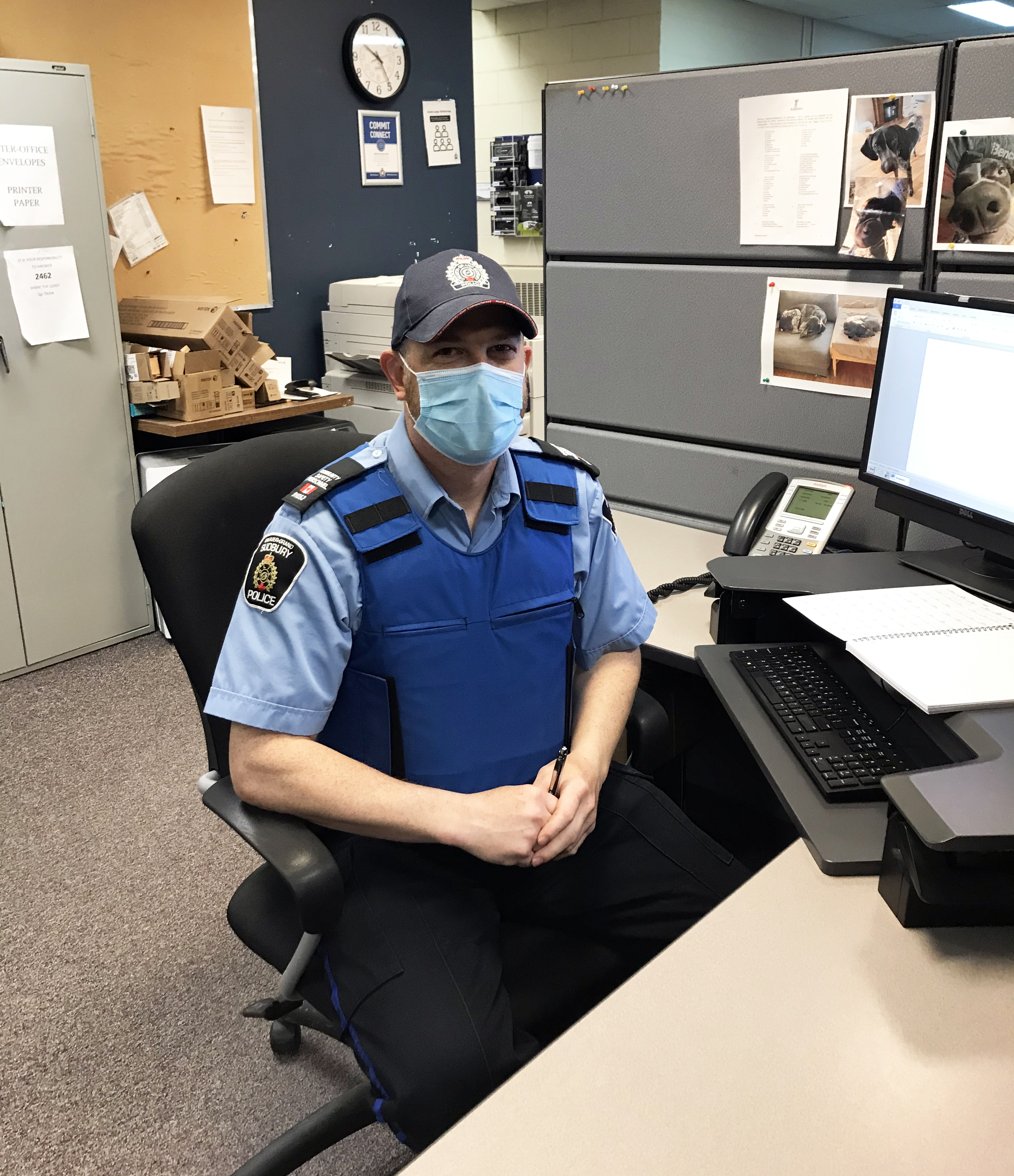 CSP Matt Pacan man in uniform sitting at desk with mask on
