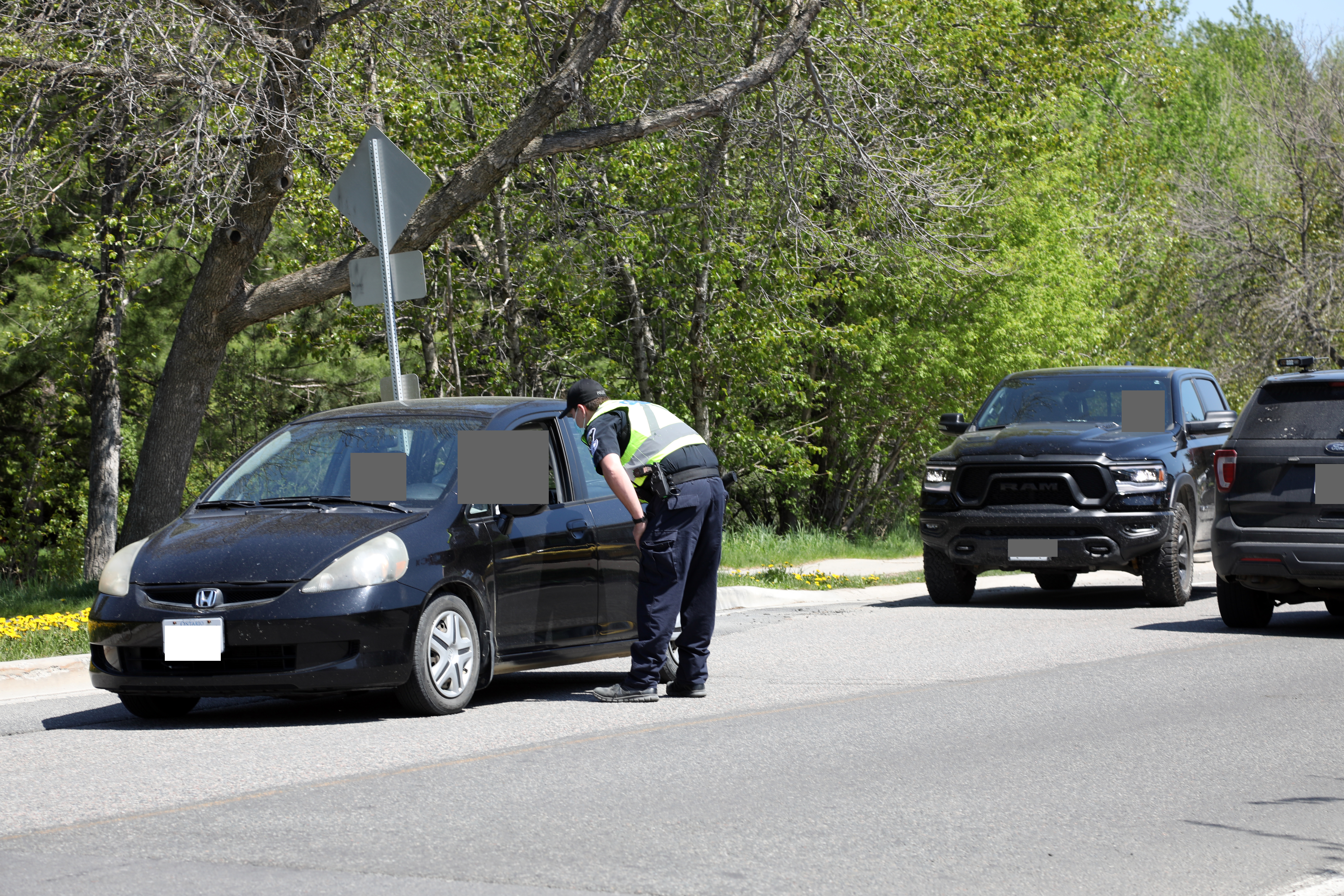 spot check Officer standing at window of vehicle on road