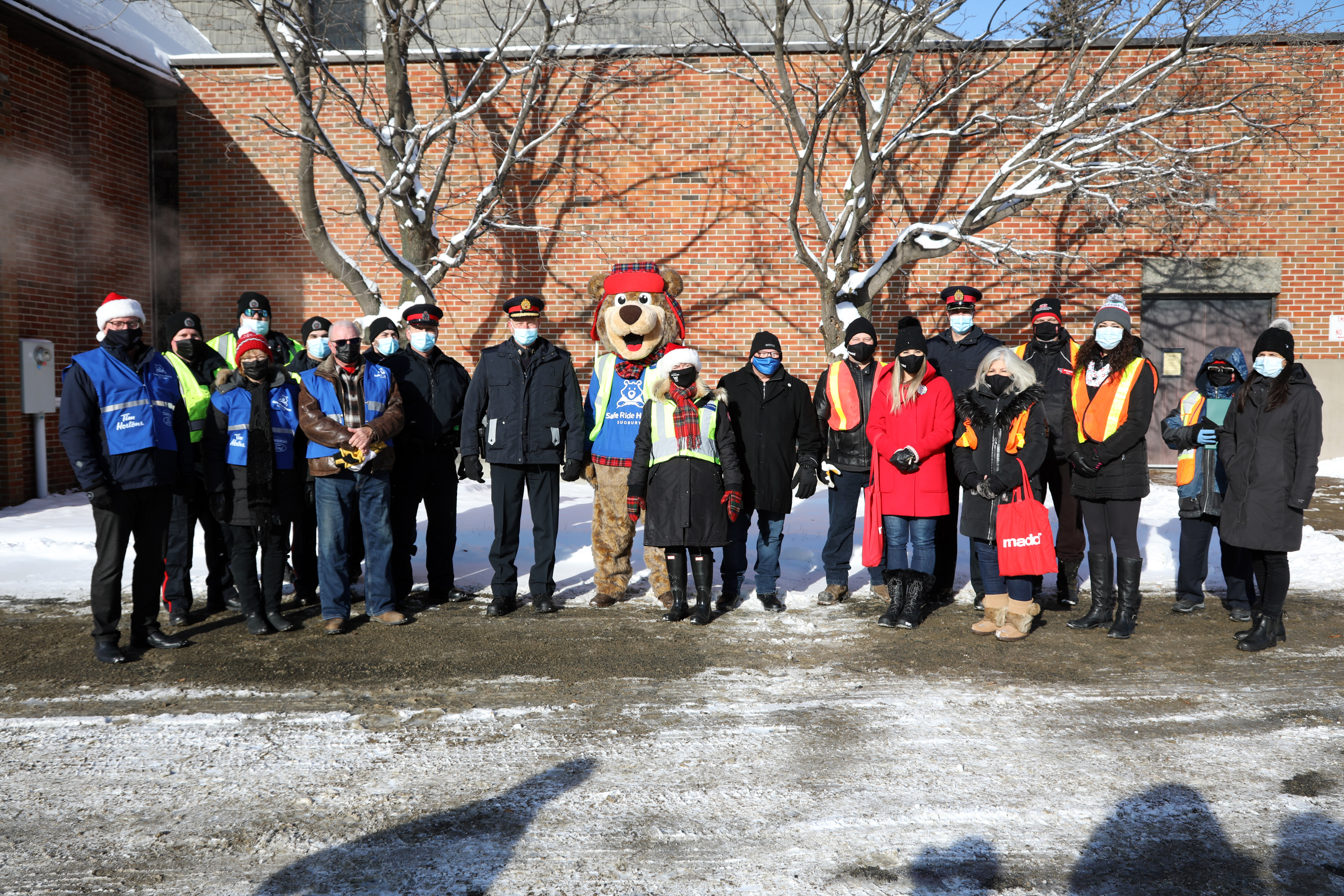 Festive RIDE launch community partners group of people standing together outside in winter