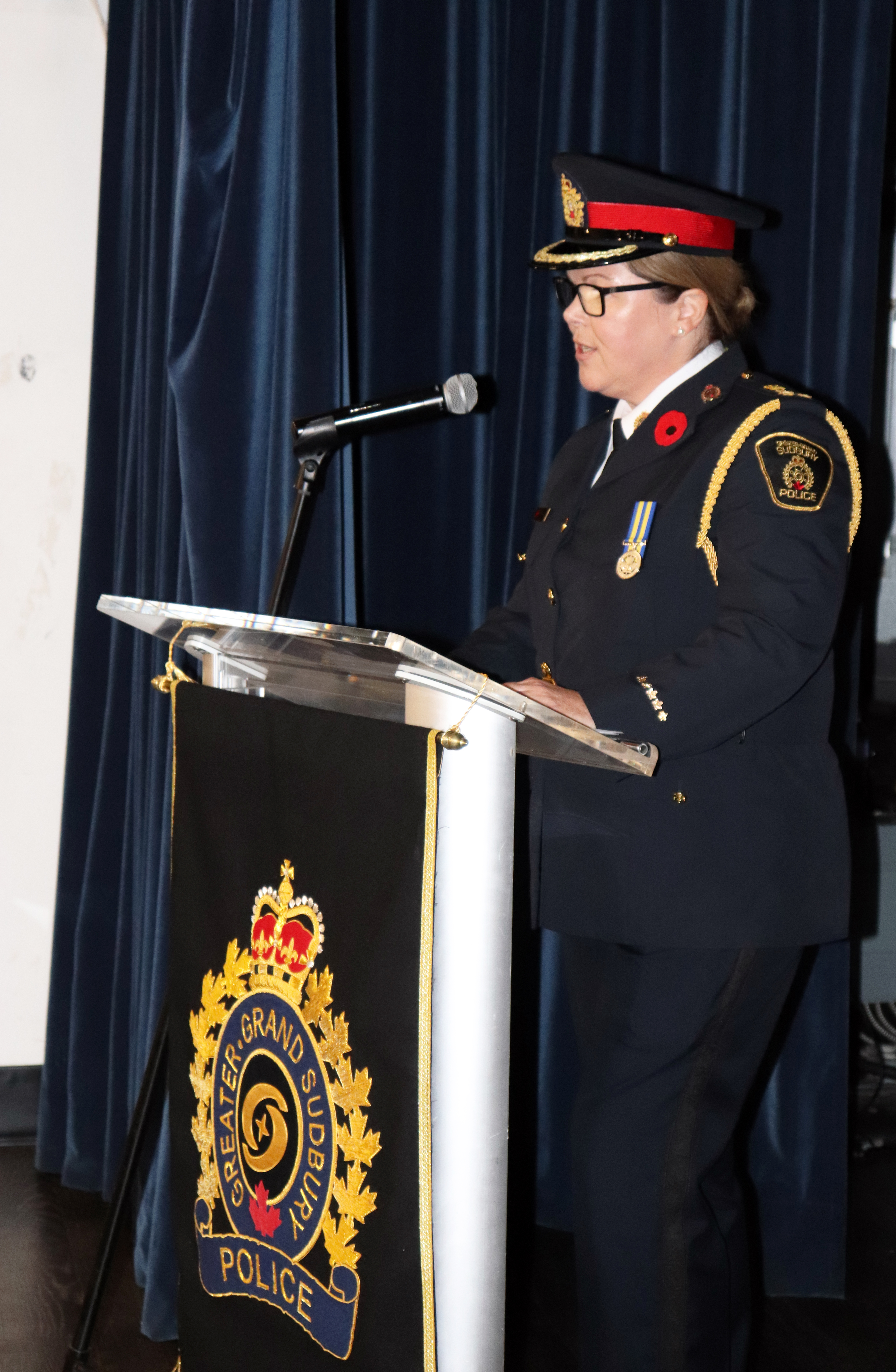 Chief Sara Cunningham woman in police uniform speaking at podium