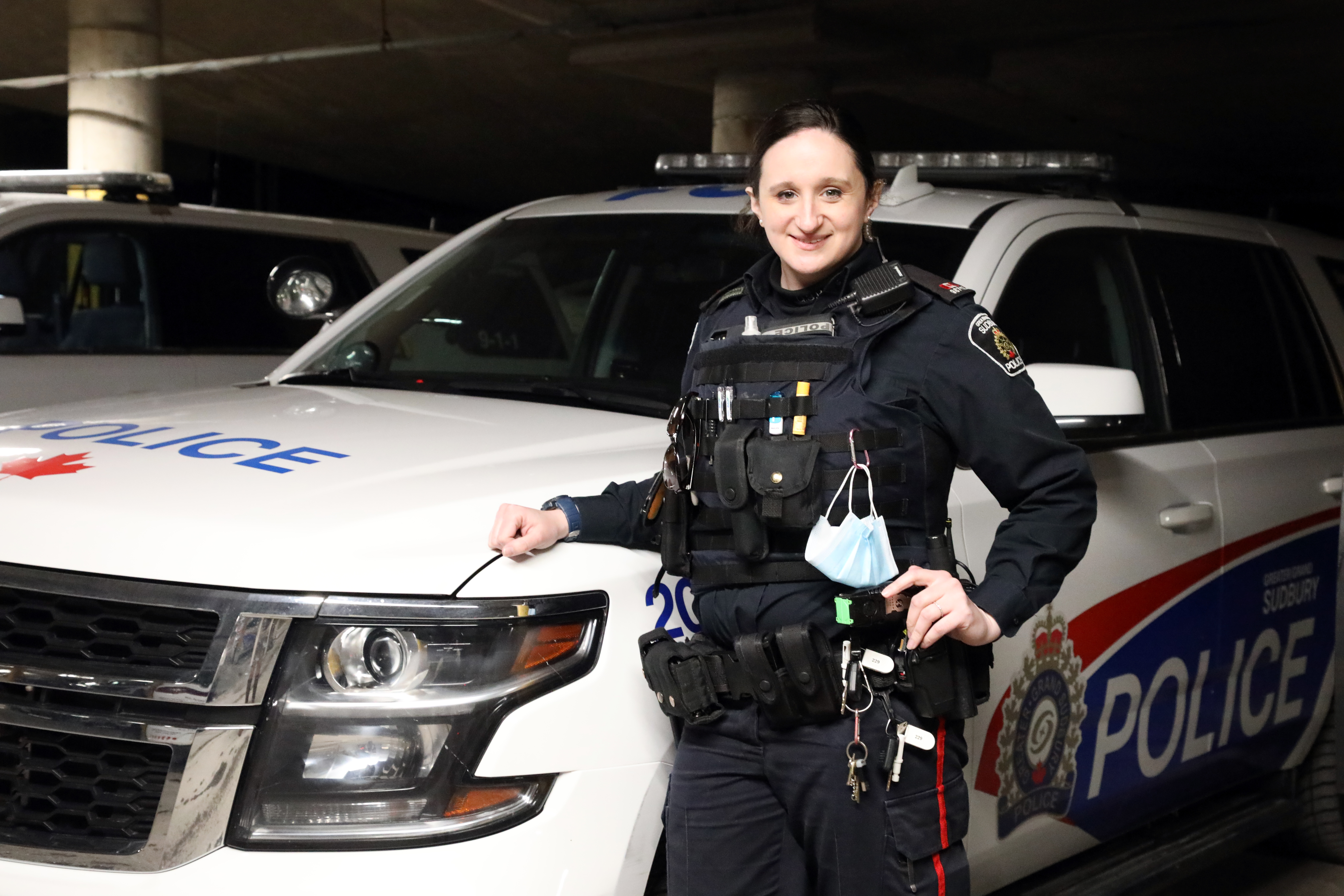 Constable Sam Insinna female officer standing beside cruiser