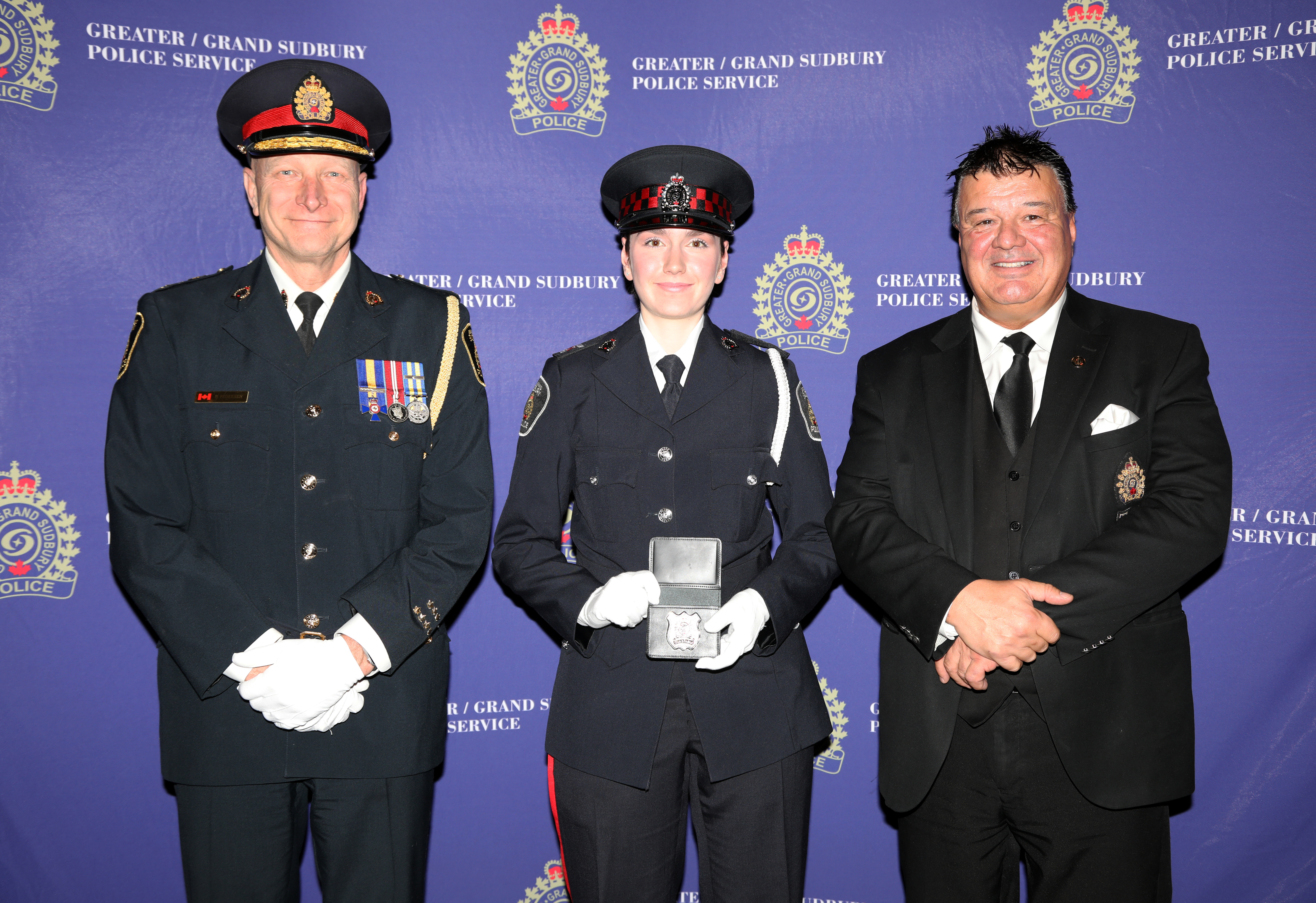 Auxiliary Constable Marina Leblanc badge presentation auxiliary officer in uniform holding badge