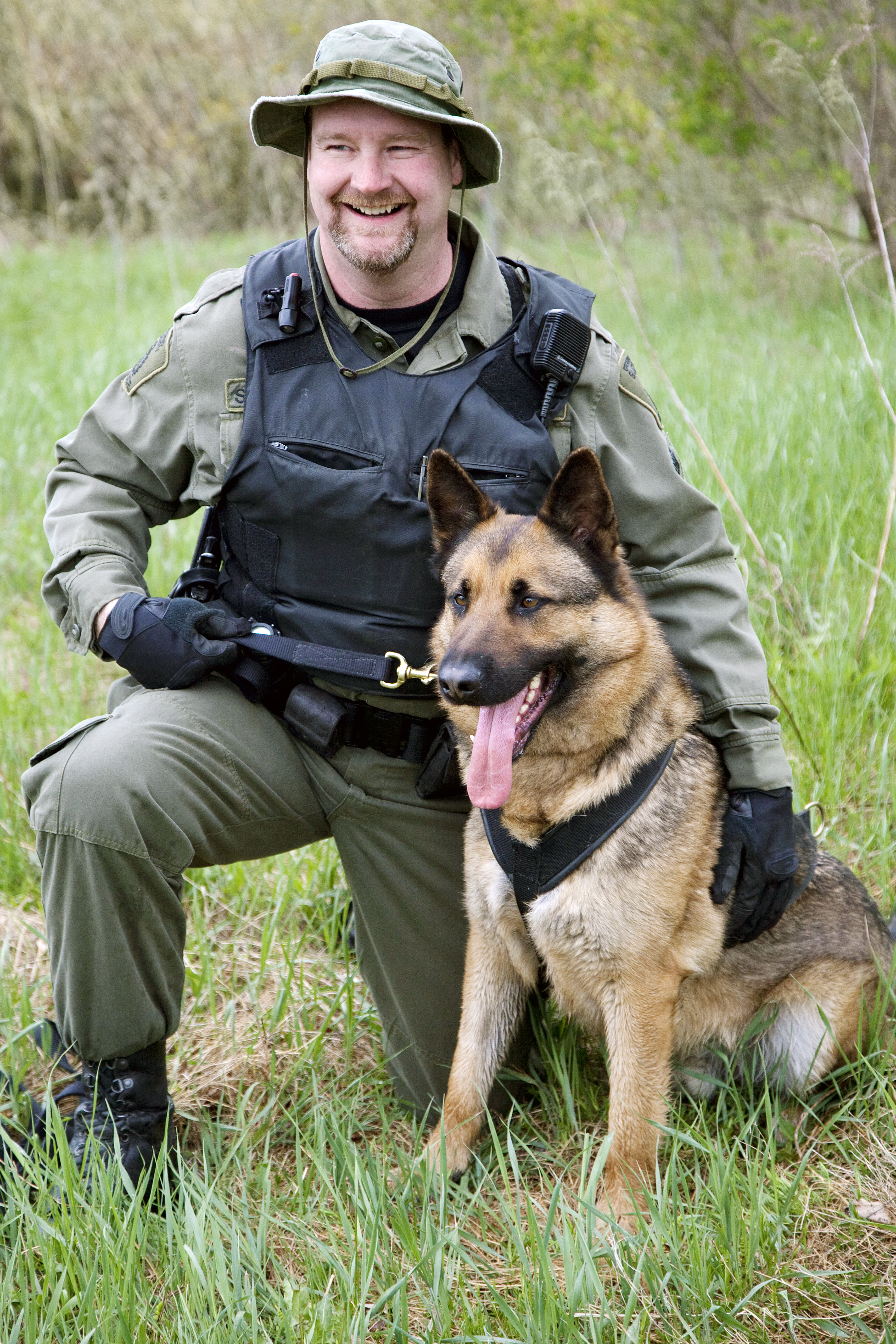 Sergeant Doug Ward and Retired K9 Scout police officer and police dog outside