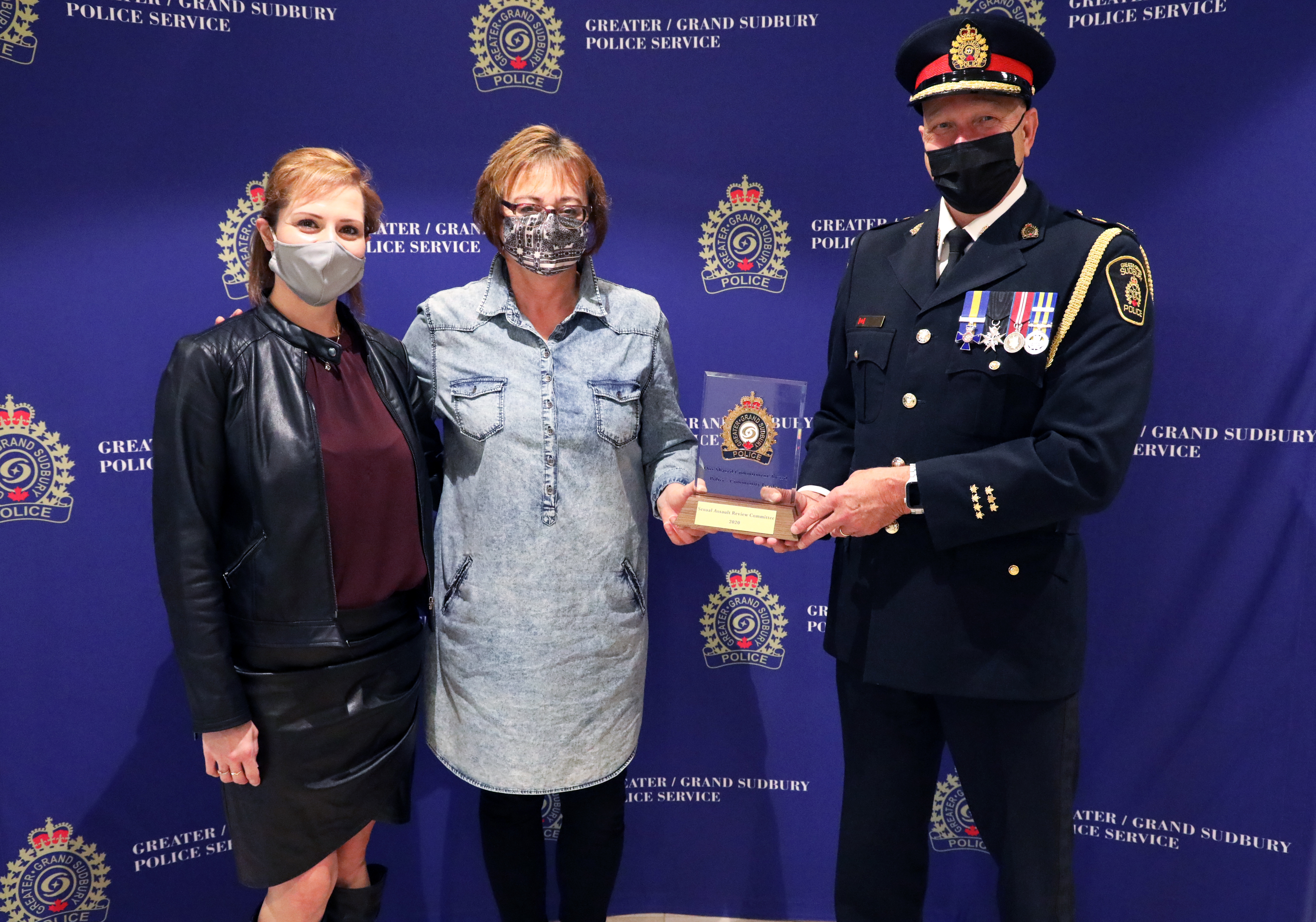 Gaetane Pharand women standing with chief of police