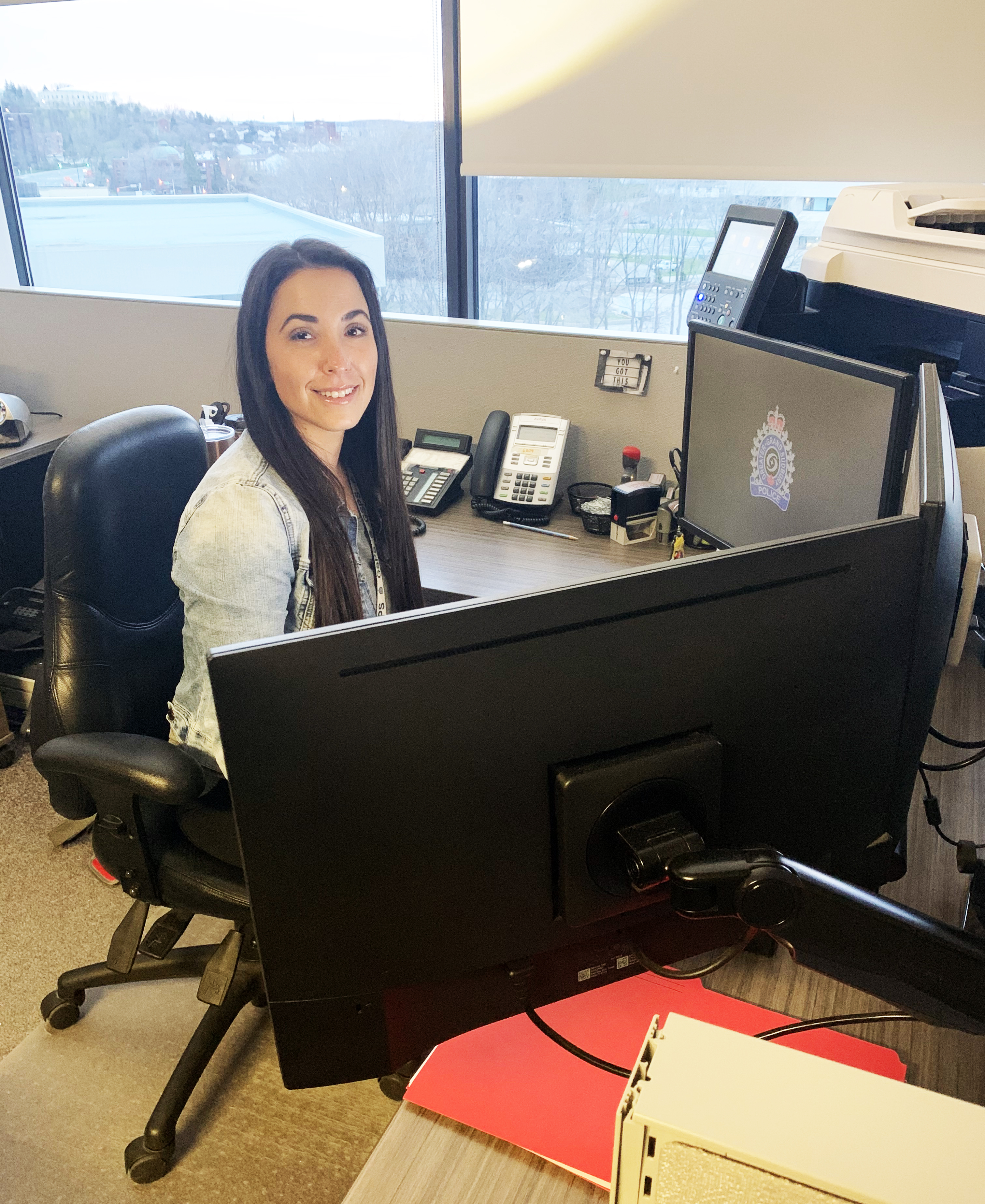 Sabrina Taylor woman sitting at computer desk smiling