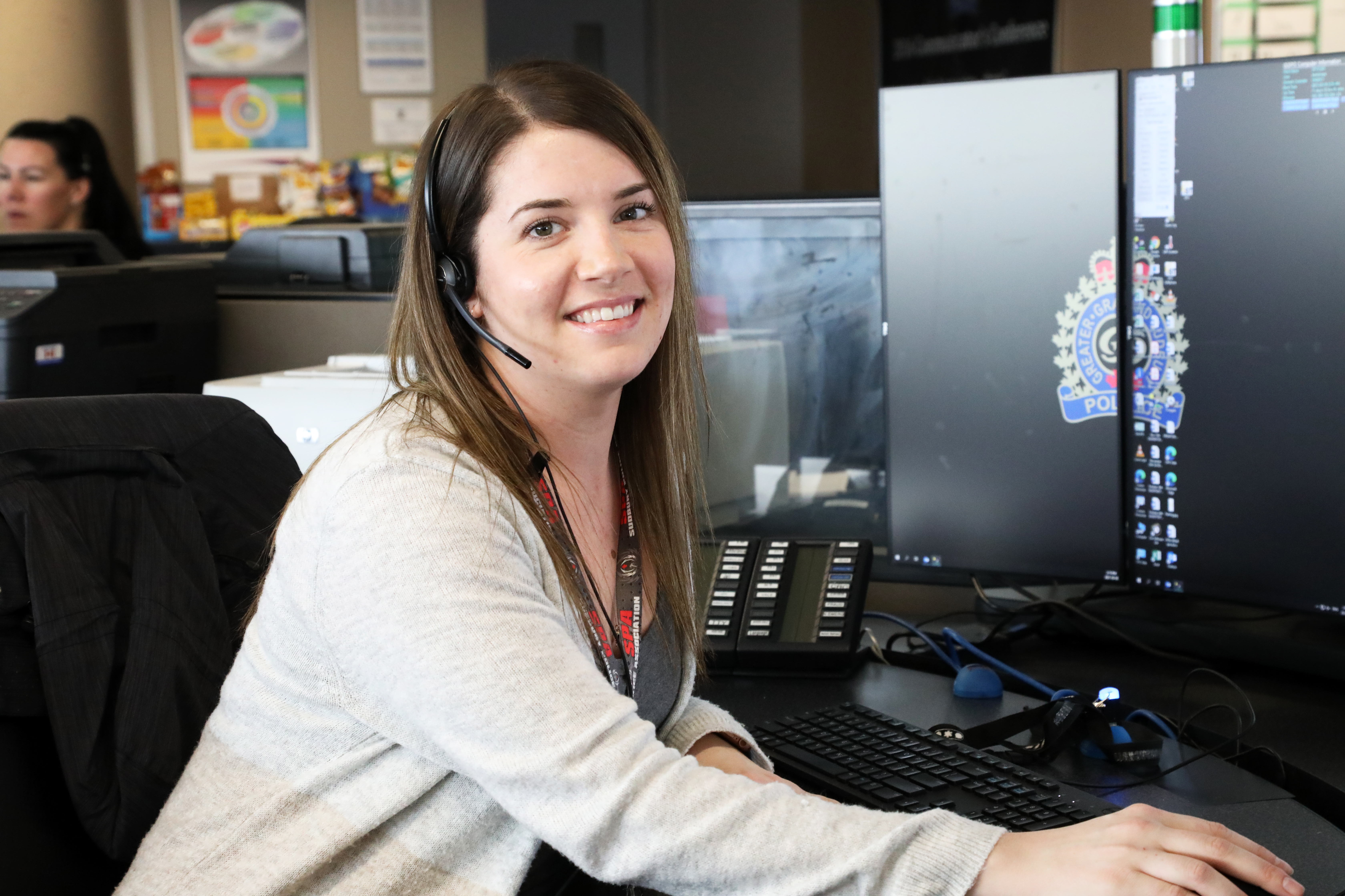 Communicator Megan Band Communicator sitting at desk smiling