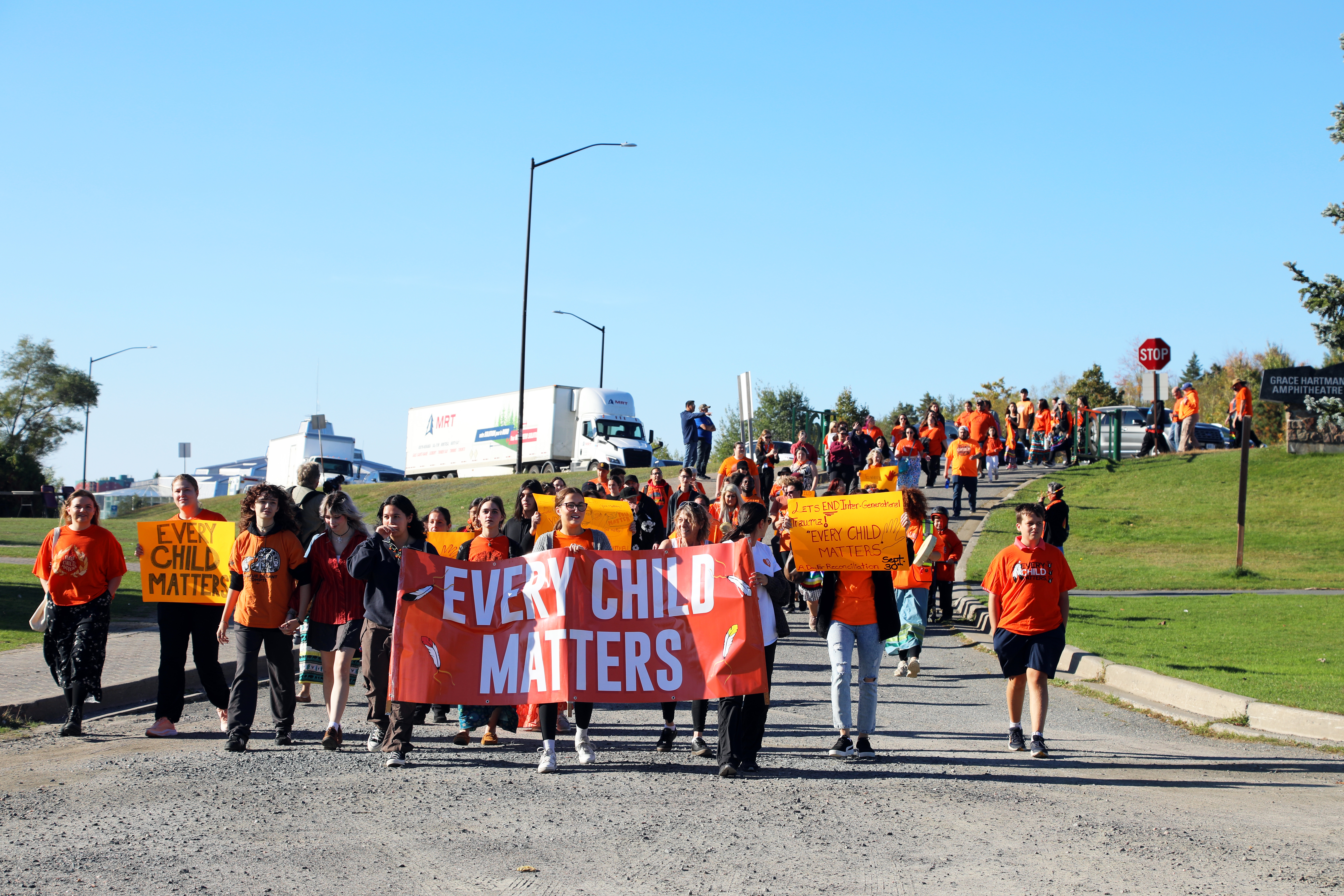 Every Child Matters group walking holding signs