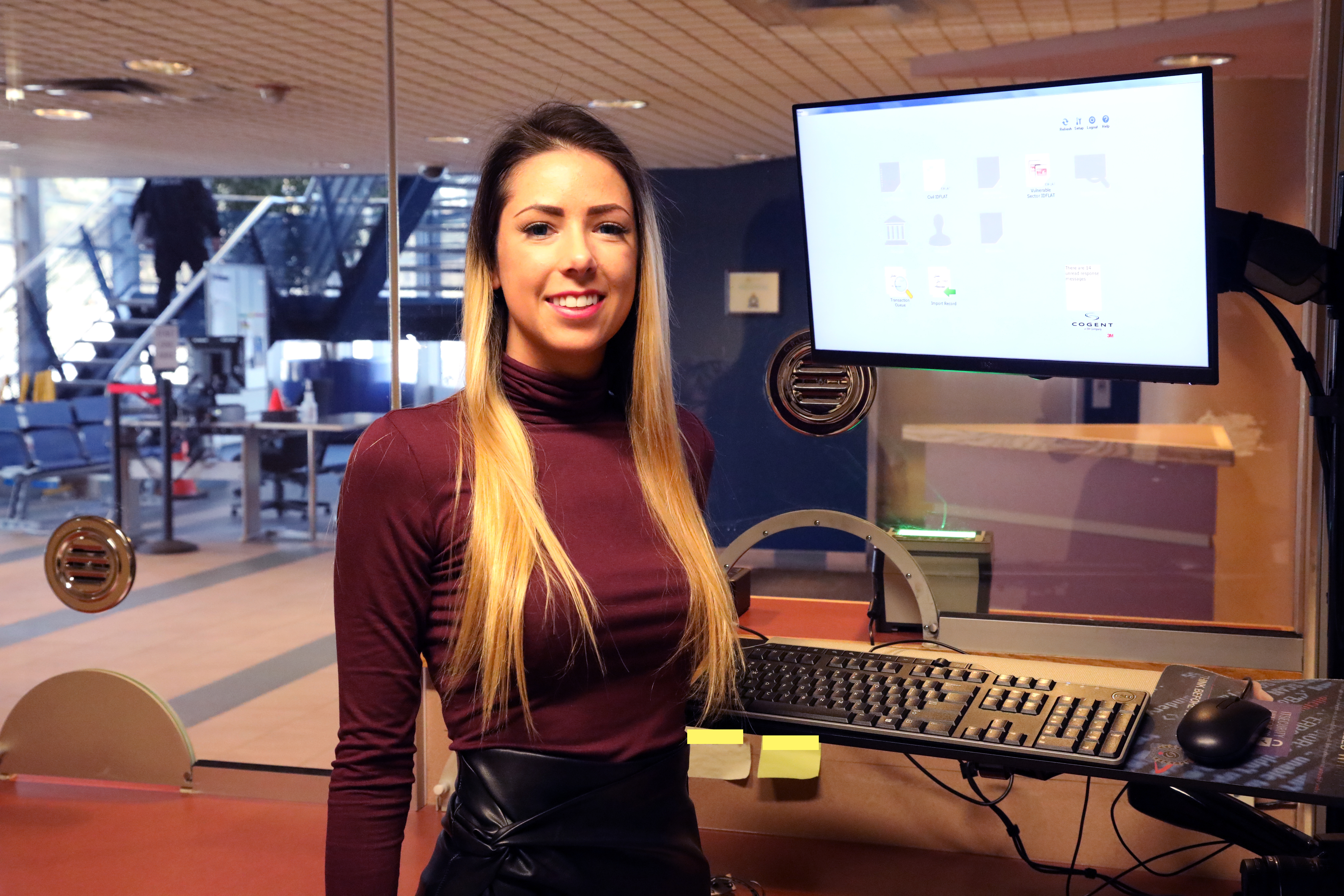 Ayla Belisle woman standing beside computer monitor