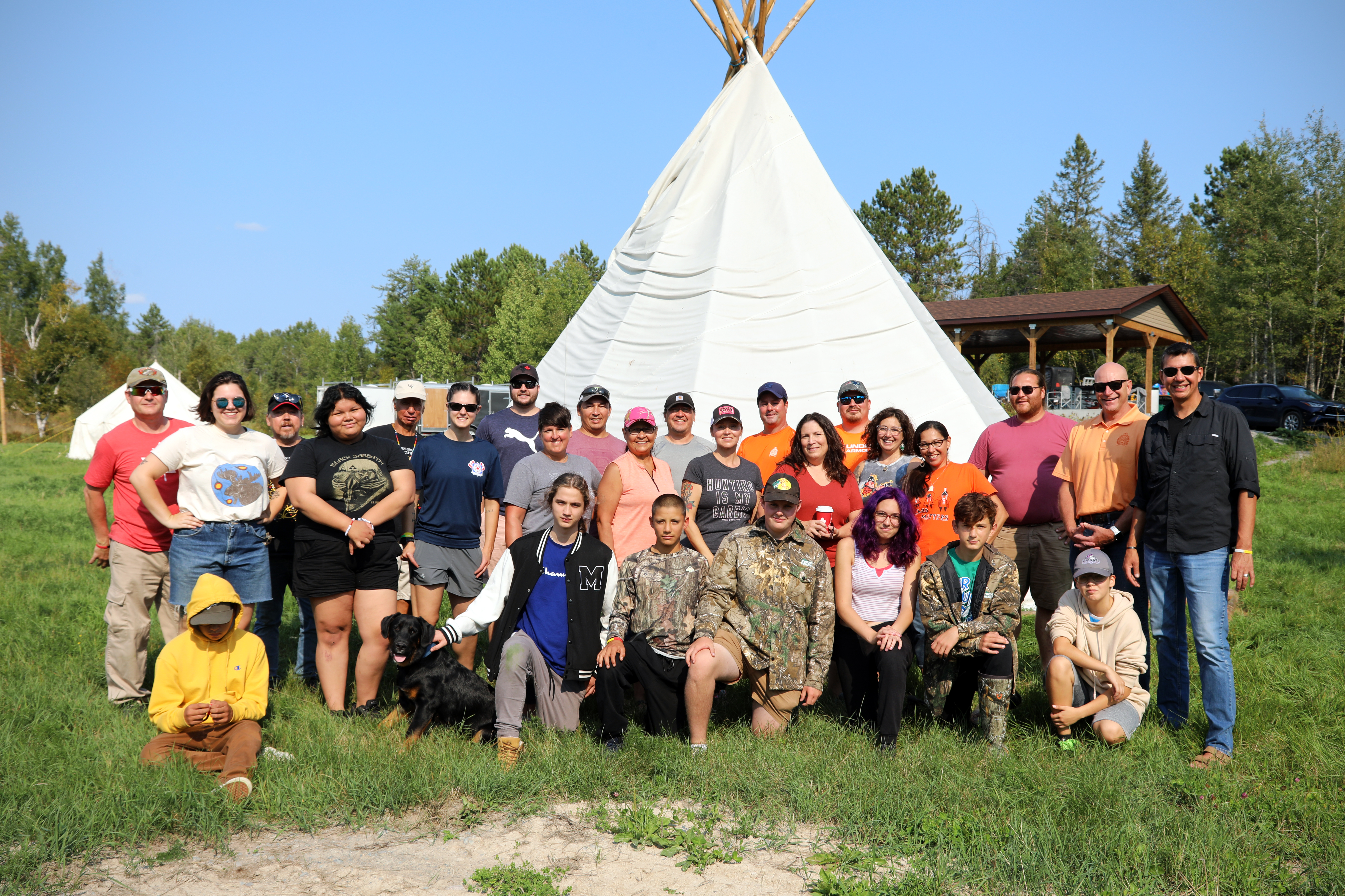 Moose Hunt Program group of people standing in front of tipi