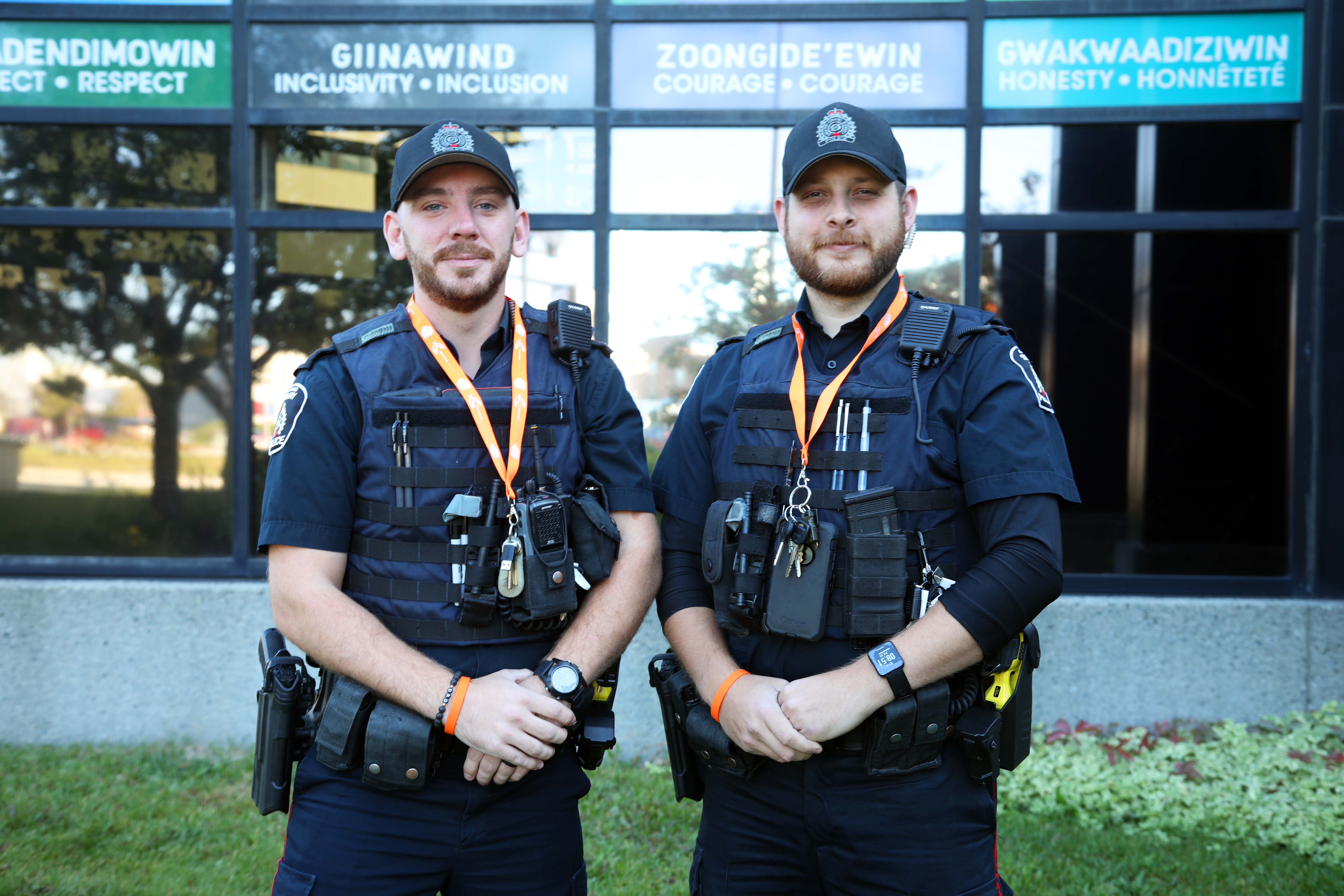 GSPS Officers wearing orange two officers in uniform wearing orange lanyards