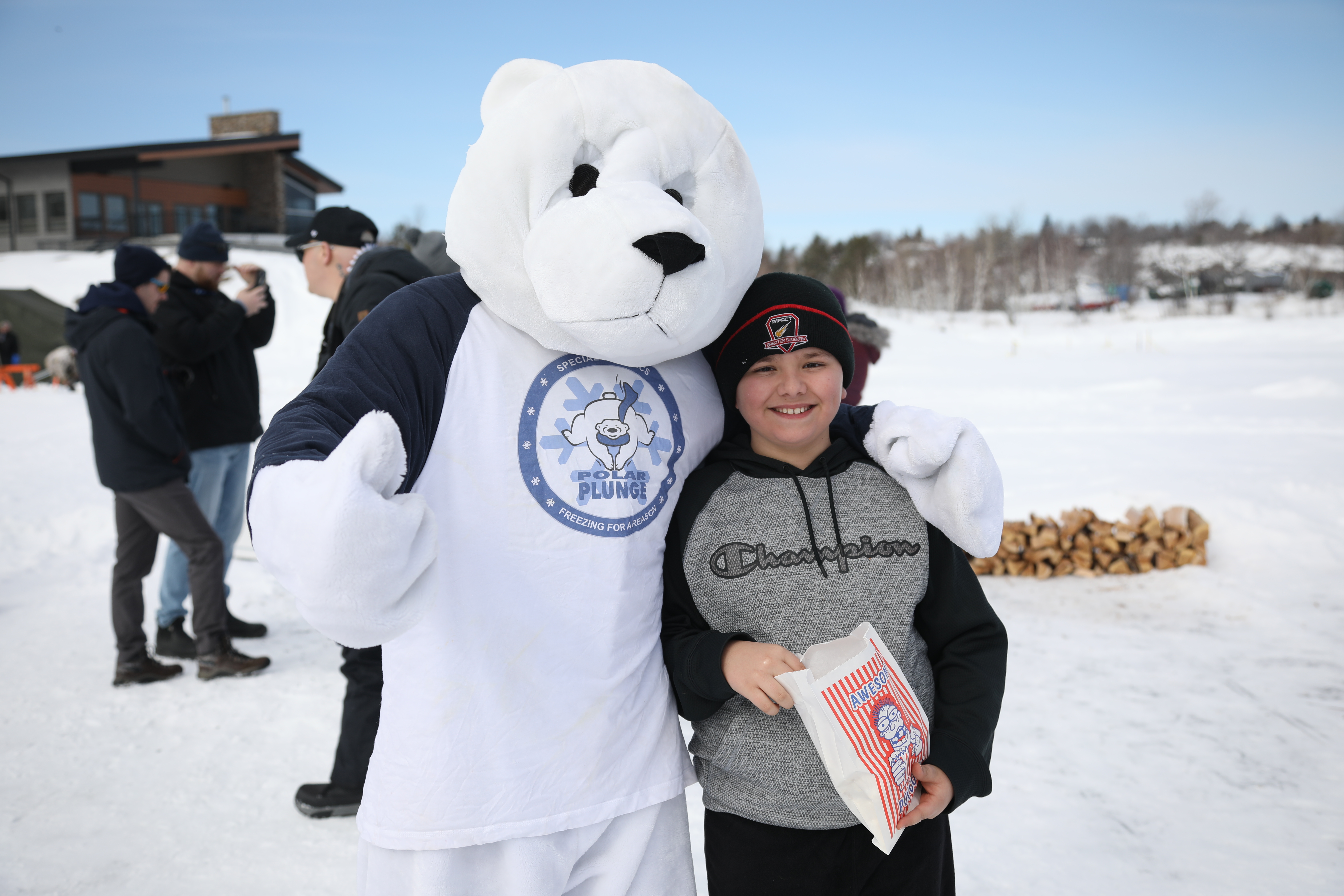 Plungee the Bear polar bear mascot standing with boy