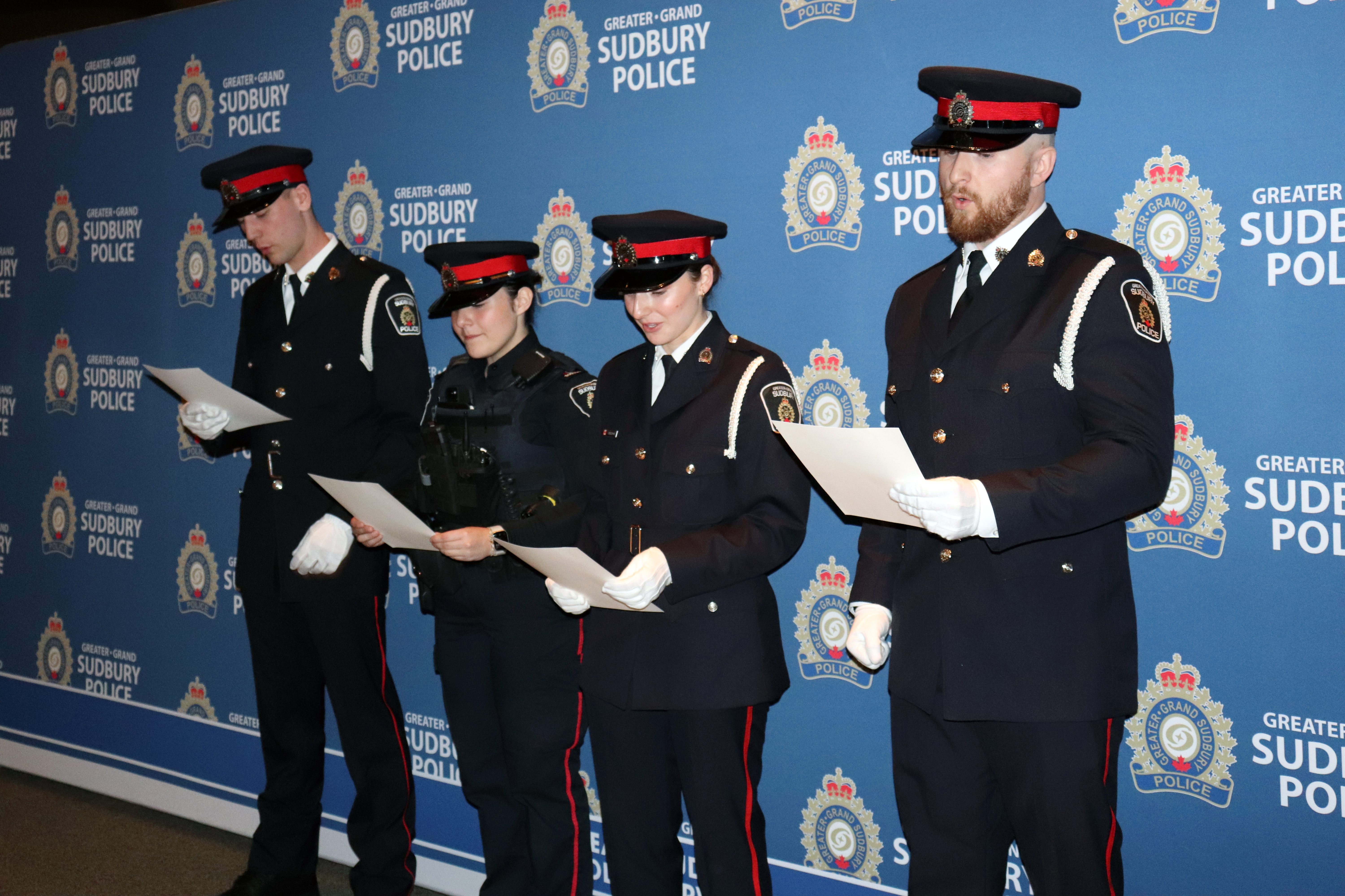 Officers reciting their oaths officers in uniform holding papers