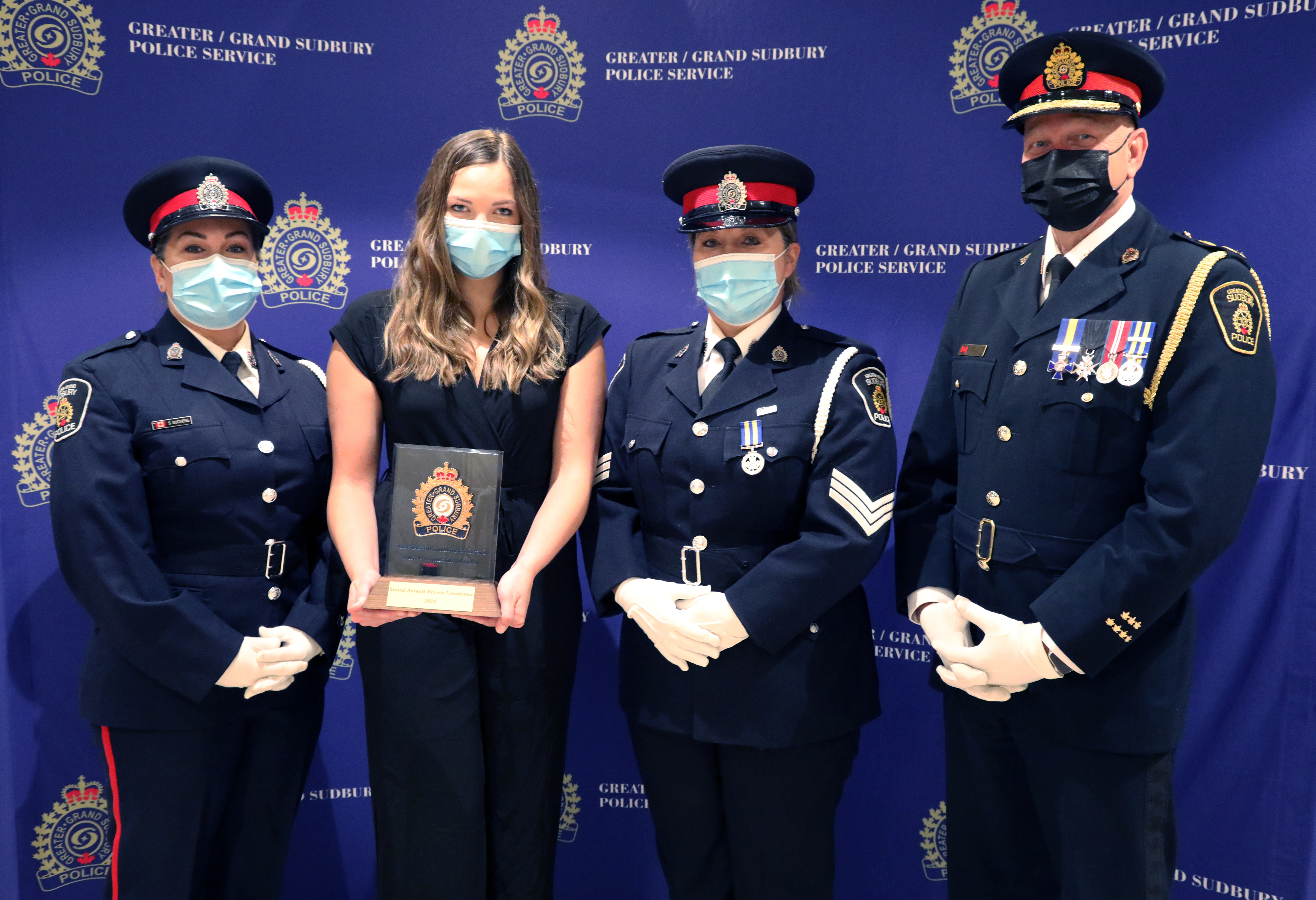 GSPS Criminal Investigations Division officers and civilian standing with chief of police