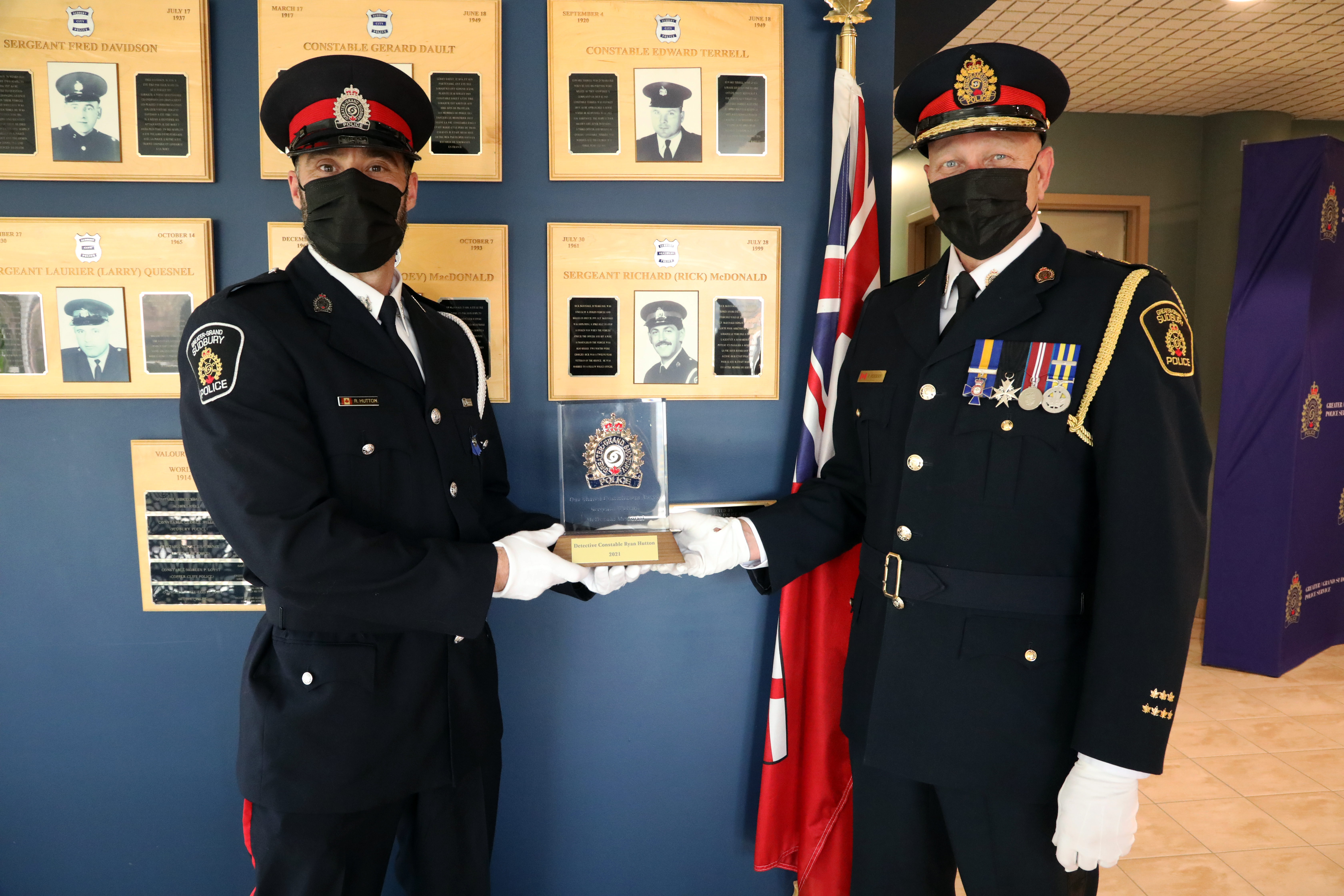 Detective Constable Ryan Hutton and Chief Pedersen Two police officers holding award