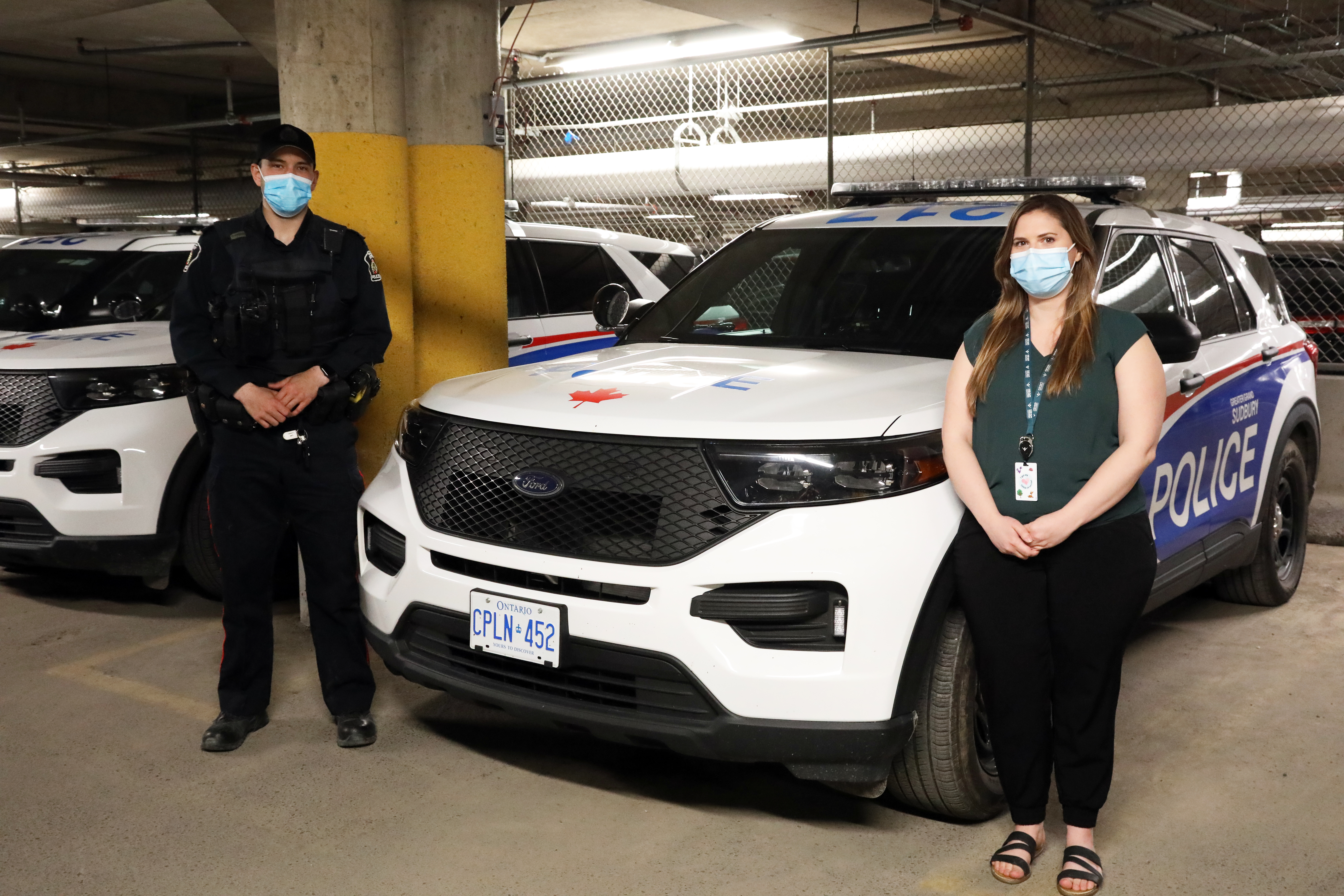 Cst. Joel Sheppard and Melanie Rail police officer and woman standing beside cruiser