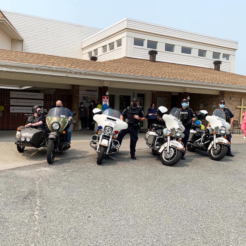 GSPS and Jim Oman at St Joseph's Villa people posing with motorcycles