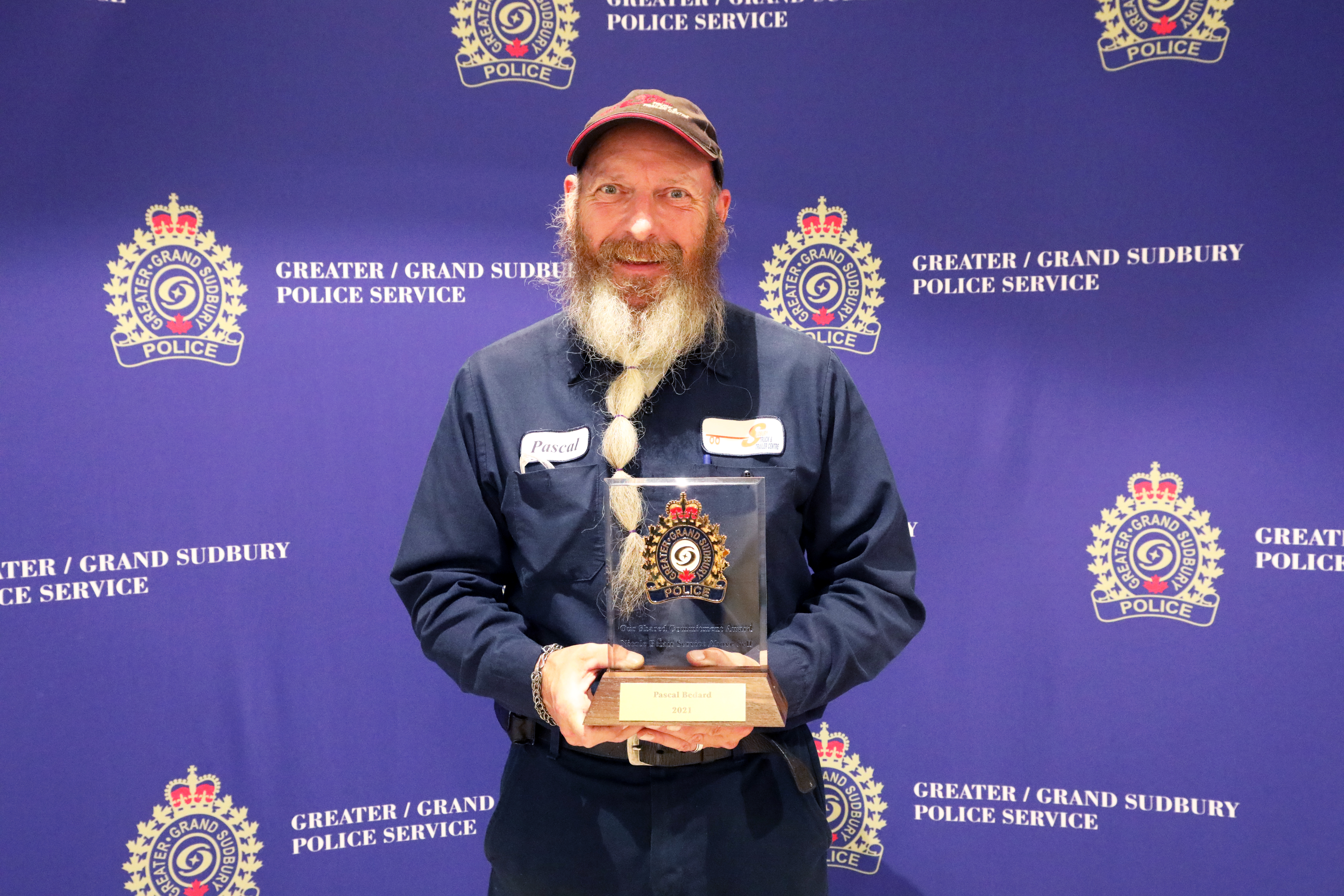 Pascal Bedard Man smiling and holding award